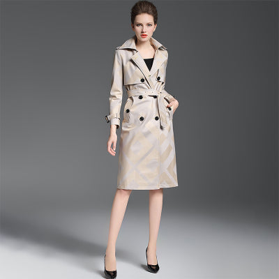 Woman wearing a beige trench coat on a gray background by millivan