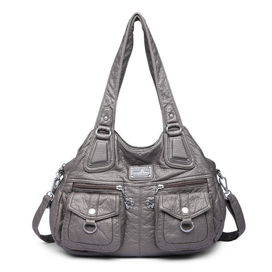 Gray handbag with multiple pockets and straps on a white background