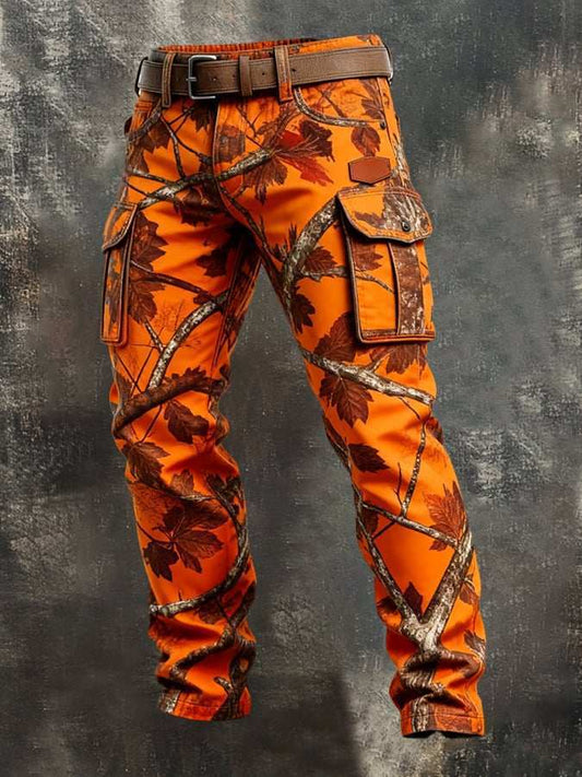 Bright orange camouflage cargo pants with a brown belt, featuring a leaf and branch pattern, displayed on a dark textured background.