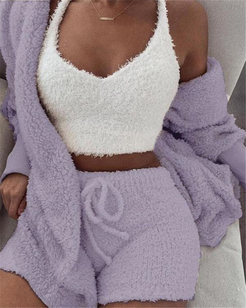 Person wearing a white textured top and purple shorts with a matching robe.