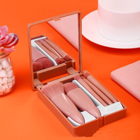 Set of lip-shaped makeup brushes in a compact case on an orange background