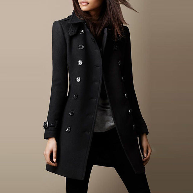 Black coat worn by a person on a beige background