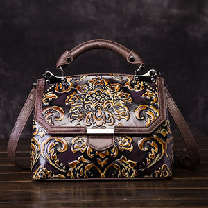 Decorative handbag with intricate gold patterns on a dark background