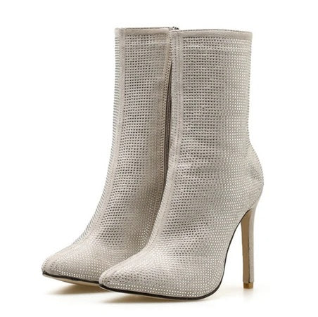 Silver stiletto heel ankle boots on a white background