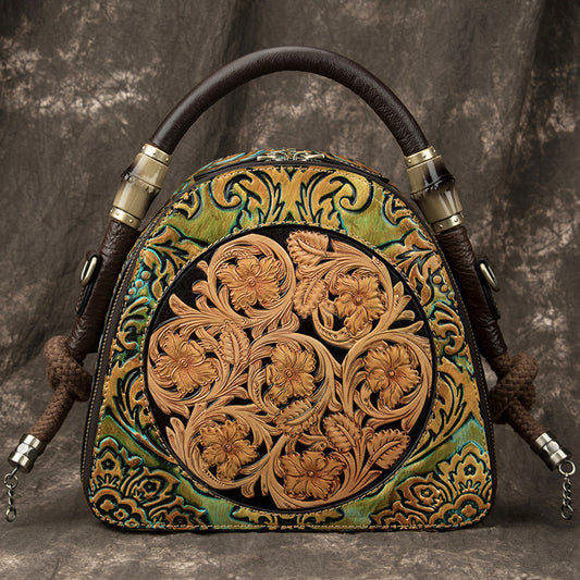 Decorative leather bag with intricate patterns on a textured gray background