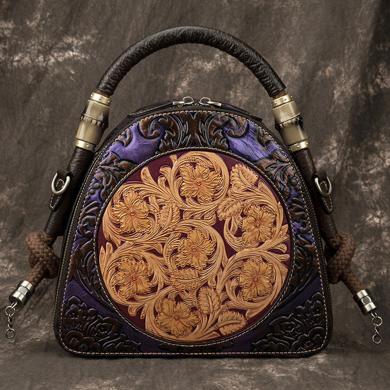 Decorative handbag with intricate leatherwork on a textured background
