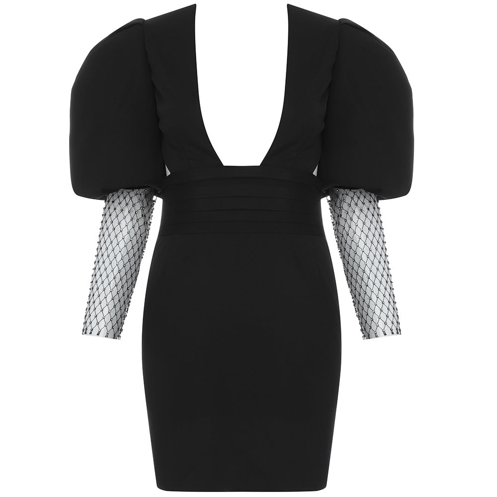 Black dress with fishnet sleeves on a white background