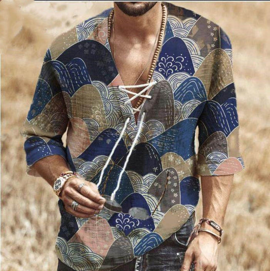 Person wearing a patterned kimono-style shirt with a blurred background