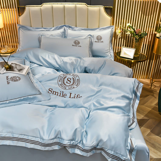Blue bedding set with 'Smile Life' logo on a bed in a stylish room.