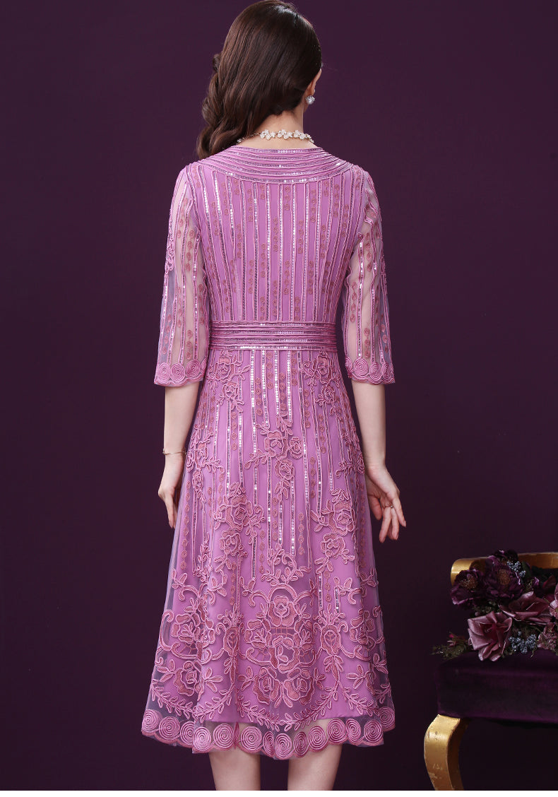 Woman wearing a pink lace dress against a purple background