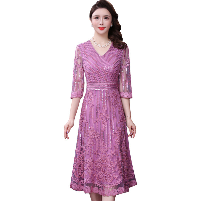 Woman wearing a purple lace dress on a white background