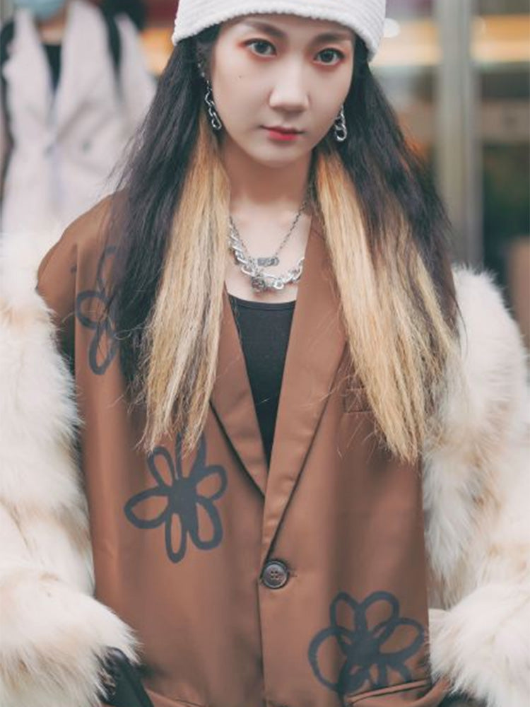 Person wearing a brown coat with floral patterns and a white fur-lined coat. by millivan