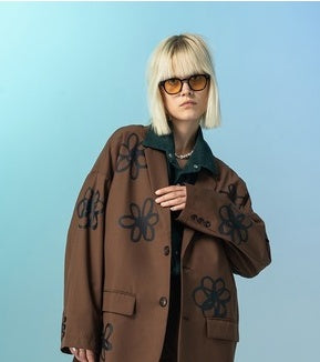 Person wearing a brown coat with floral patterns on a light blue background by millivan