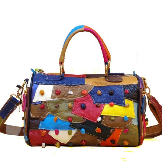 Colorful patchwork handbag with multicolored handle on a white background