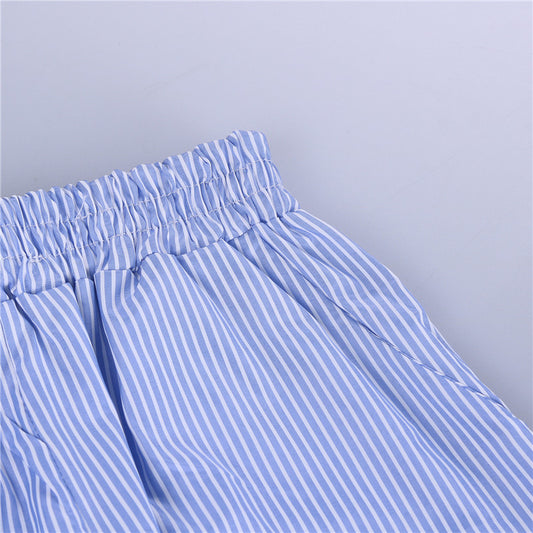 Close-up of blue and white striped pants with a plain background