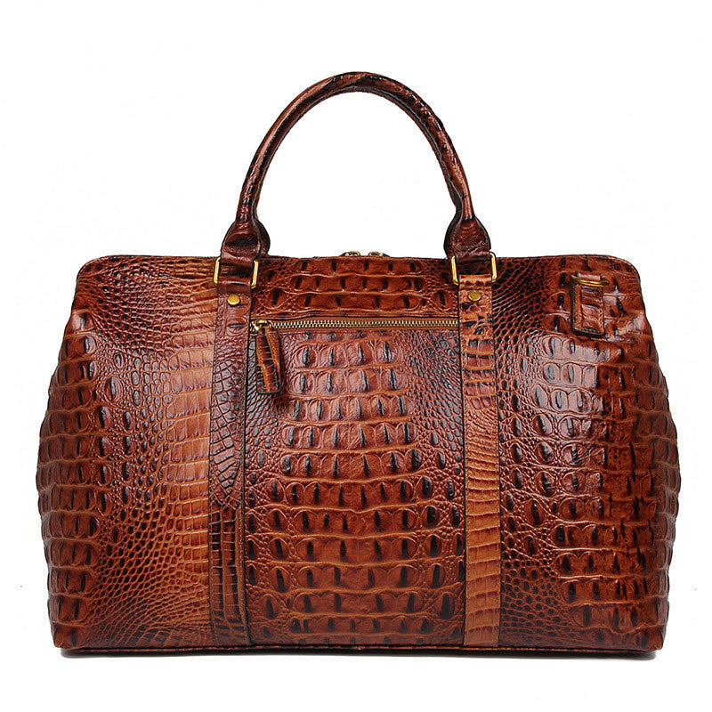 Brown crocodile-patterned leather bag on a white background