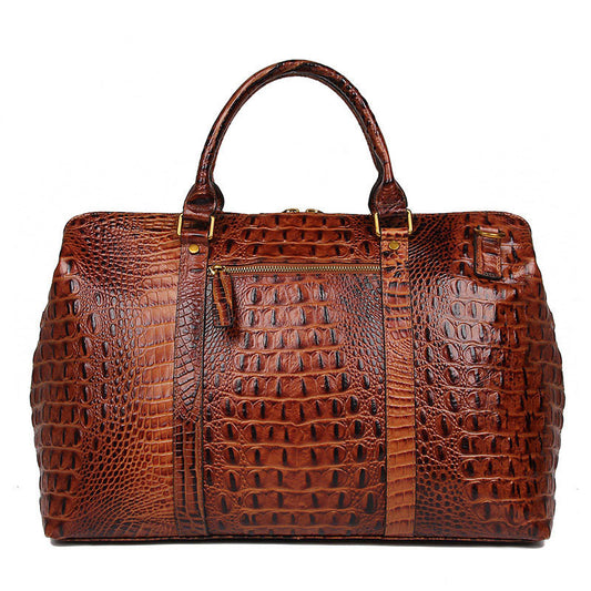 Brown crocodile-patterned leather bag on a white background