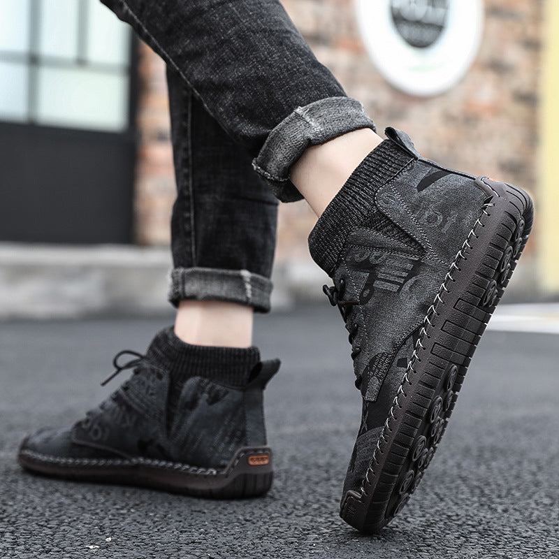 Person wearing black high-top sneakers with a blurred background