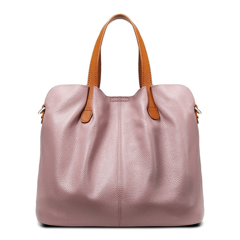 Pink handbag with brown handles on a white background