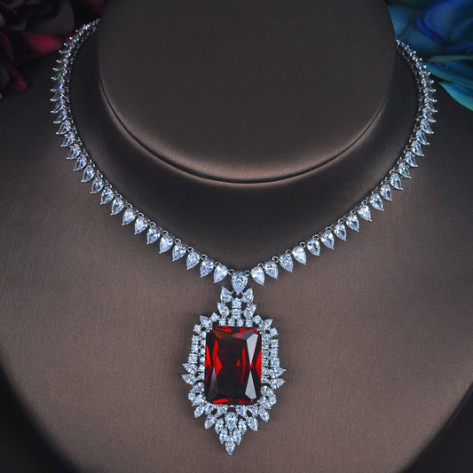 Elegant necklace with a red gemstone pendant on a dark background