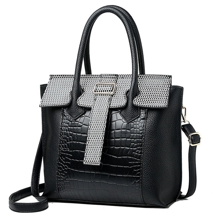 Black handbag with silver accents on a white background