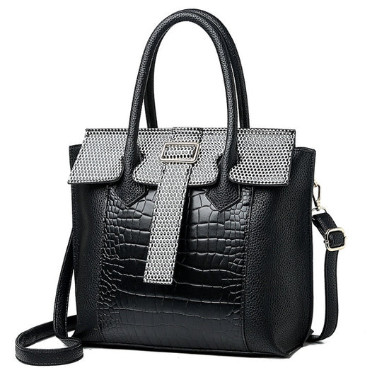 Black handbag with silver accents on a white background