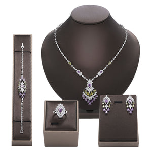 Jewelry set including necklace, bracelet, and earrings on a mannequin bust with display boxes.