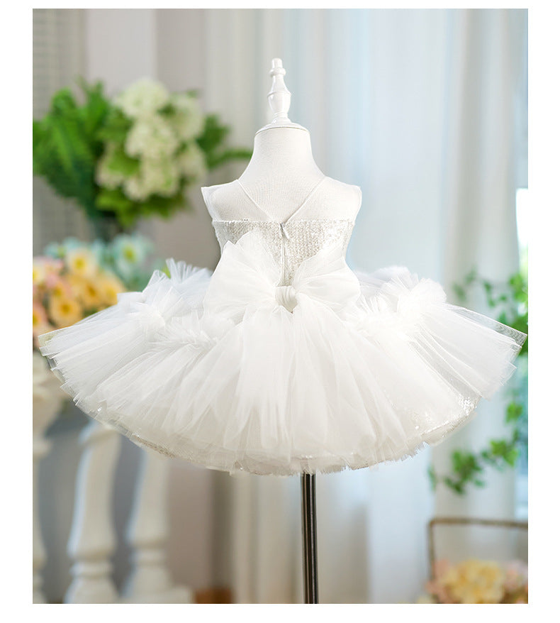 White tutu dress on a mannequin with a blurred floral background