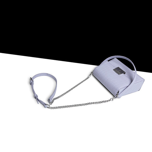 Light blue handbag with a chain detail on a white background