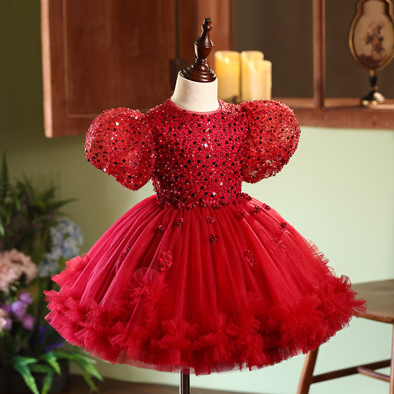 Red sequin dress on a mannequin against a home interior background
