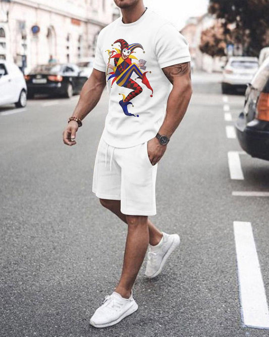 Man wearing a white t-shirt with a colorful graphic design and white shorts on a city street.