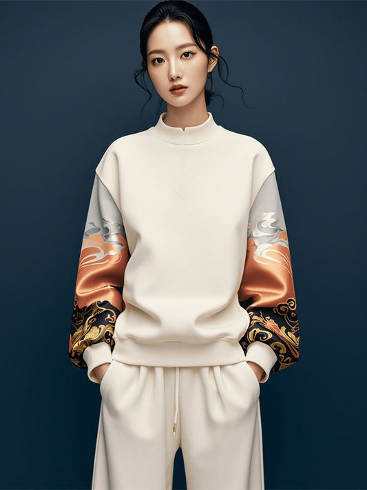Person wearing a cream-colored outfit with patterned sleeves on a dark blue background
