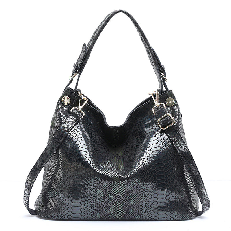 Black textured handbag with gold accents on a white background