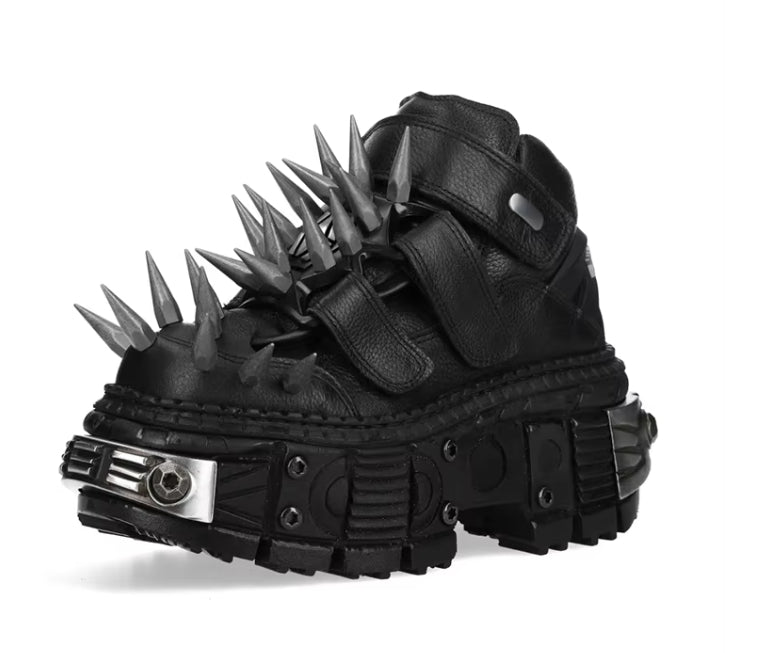 Black spiked and metallic boot on a white background