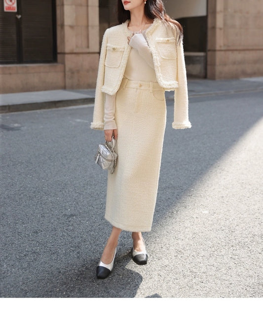 Woman in a beige suit walking on a street