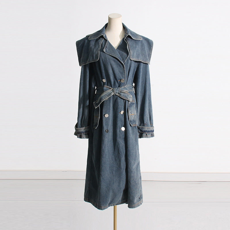 Denim trench coat on a mannequin against a white background