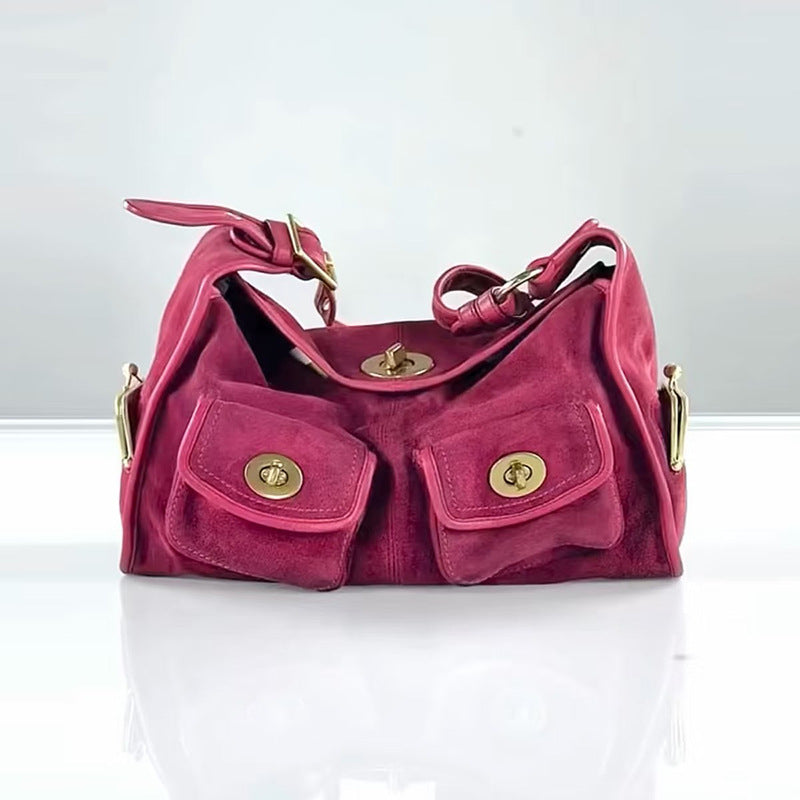 Pink handbag with gold accents on a white background