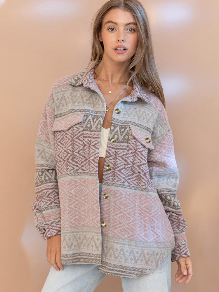 Woman wearing a patterned cardigan against a beige background