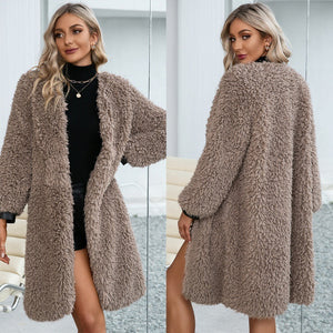 Woman wearing a fluffy beige coat in a minimalistic setting