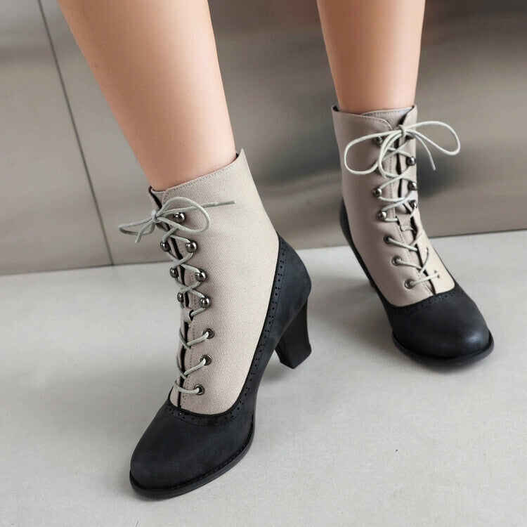 Black and beige lace-up boots on a neutral background