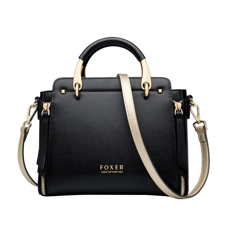 Black handbag with gold accents and 'FOXER' branding on a white background