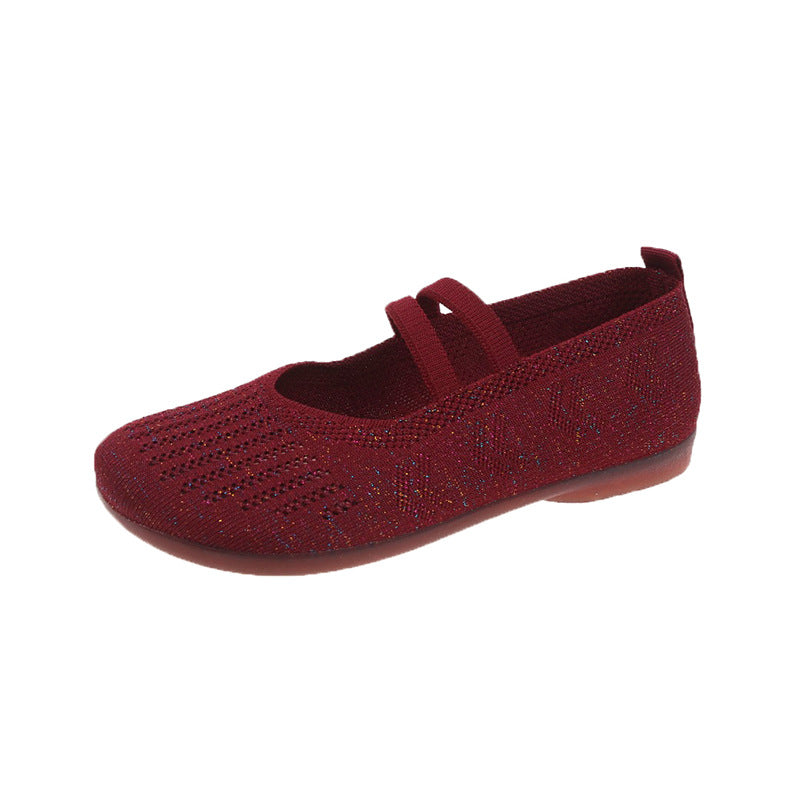 Red flat shoe with a single strap on a white background