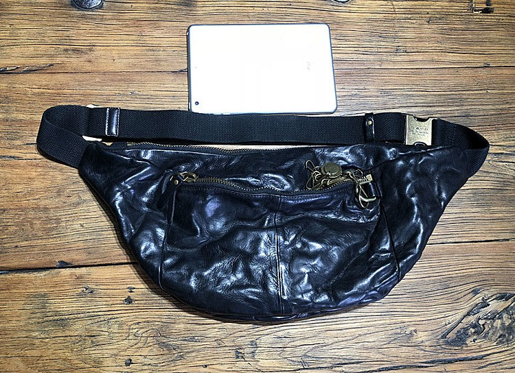 Black leather fanny pack on a wooden surface