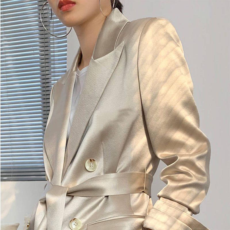 Beige blazer worn by a person with a neutral background by millivan
