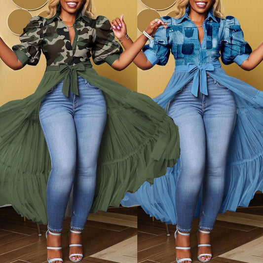 Two women wearing matching outfits with green and blue dresses over jeans.