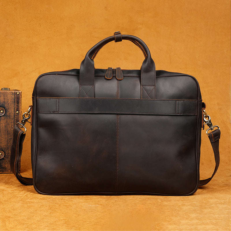 Black leather briefcase on a brown background
