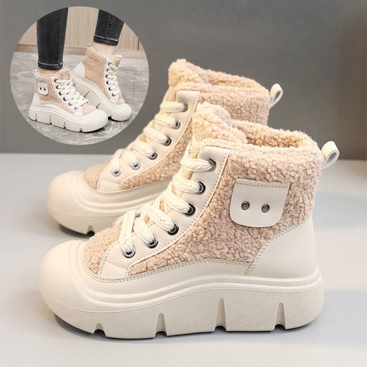 Beige high-top sneakers with white laces on a light gray background