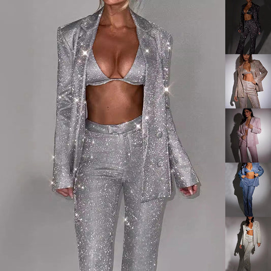 Silver glittery suit with matching bra and pants on a gray background