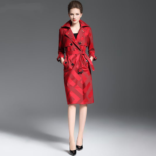 Woman wearing a red trench coat on a gray background by millivan
