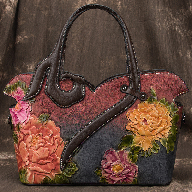 Handbag with floral designs on a textured brown background
